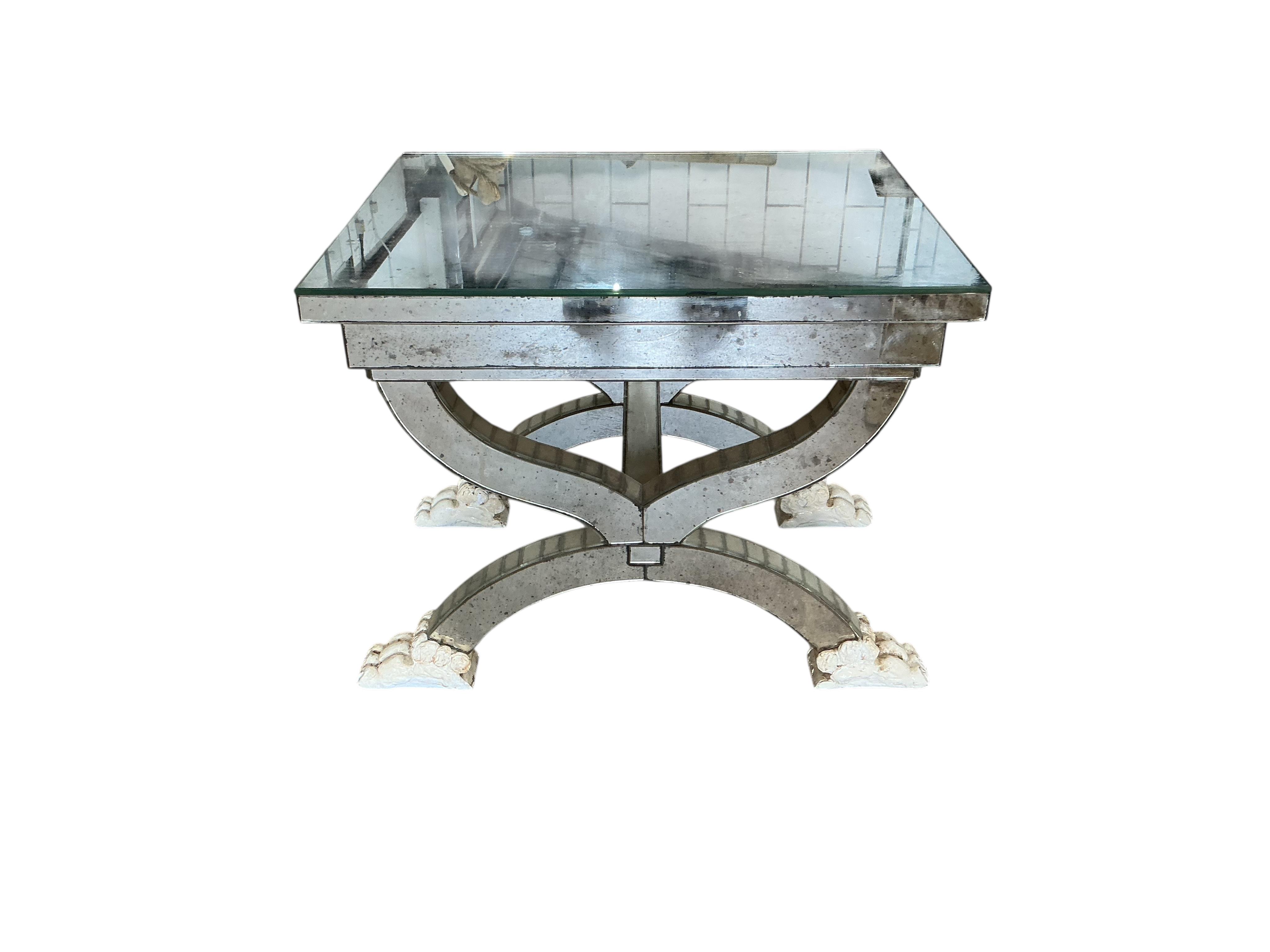 A mirror panelled X-framed lamp table, on four cream painted lion paw feet, width 56cm, depth 46cm, height 48cm